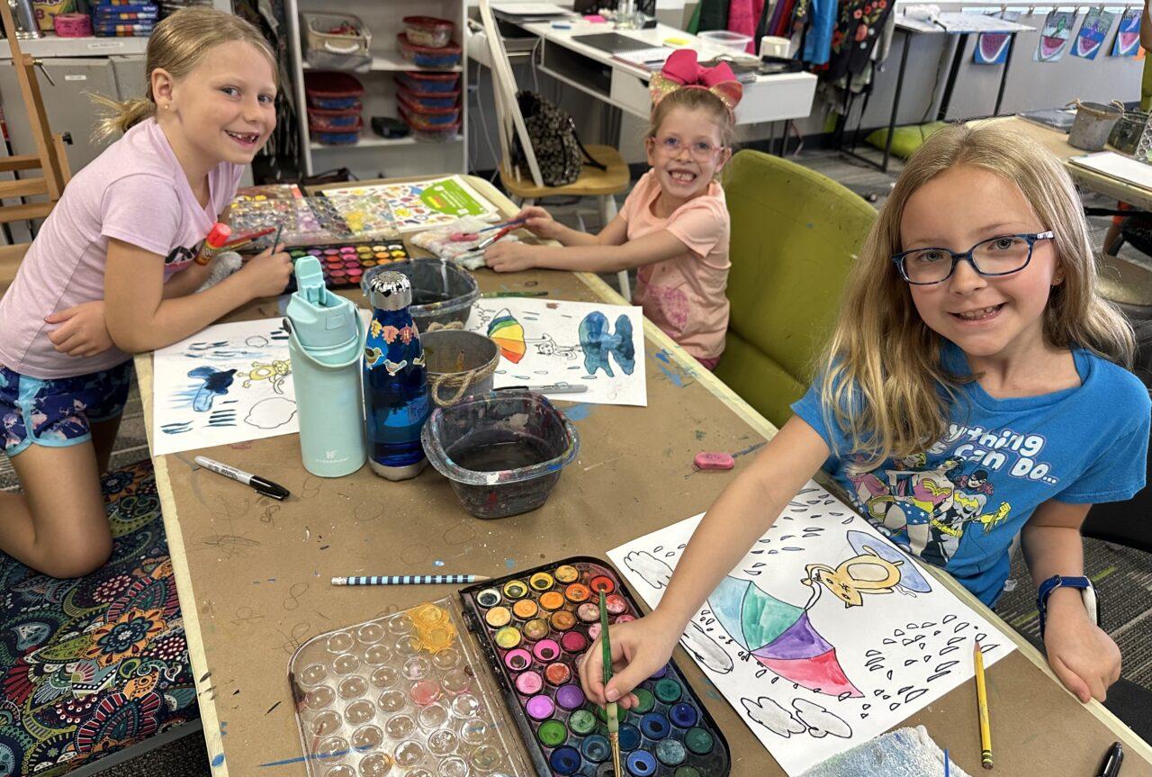 Kids doing art work during the Art Camp